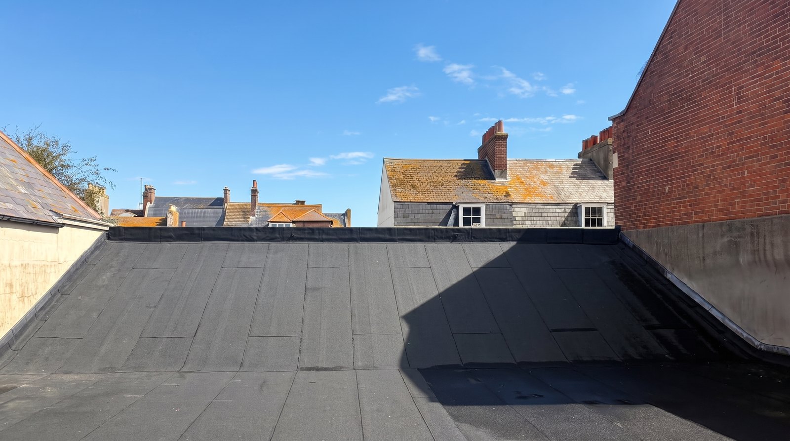 Newly re-covered commercial flat roof in Weymouth town centre, wide view